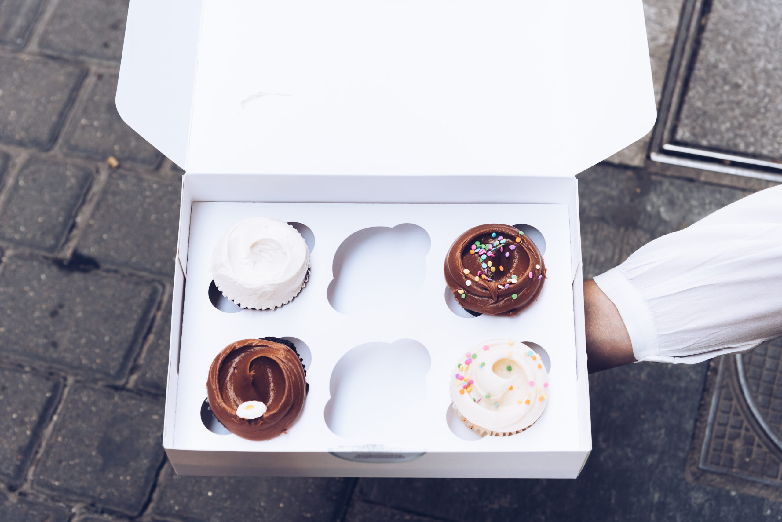 assorted gourmet tasty cupcakes on a carboard box 2026 01 08 22 00 00 utc