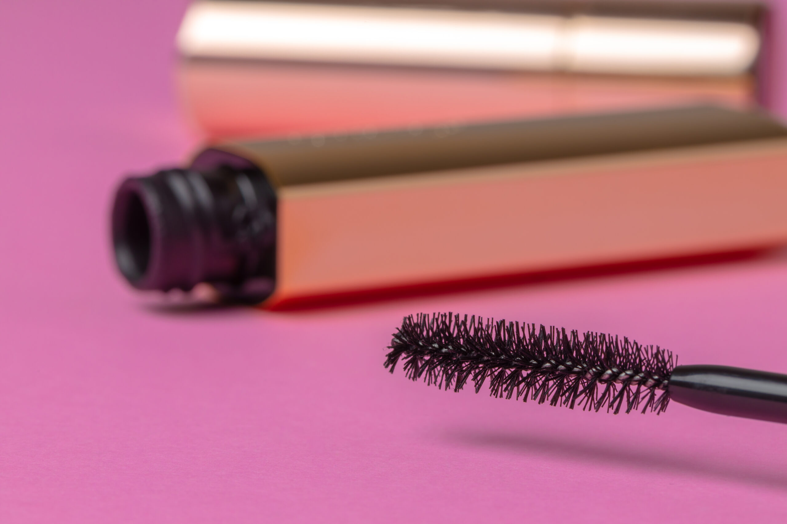 gold tube of mascara close up on pink background 2026 03 24 11 38 05 utc