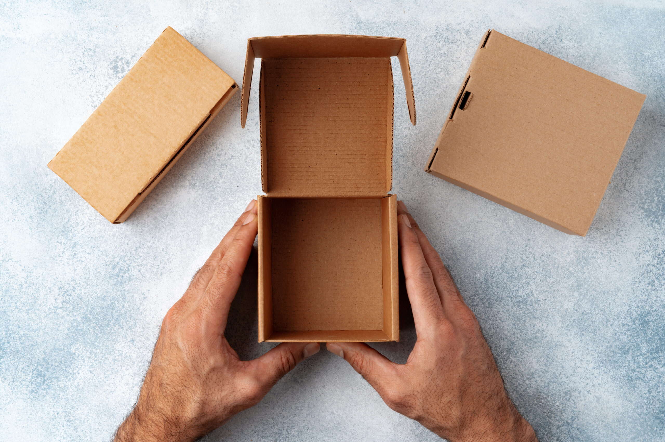 parcel cardboard box in a man hands on a gray tabl 2026 03 24 00 07 03 utc