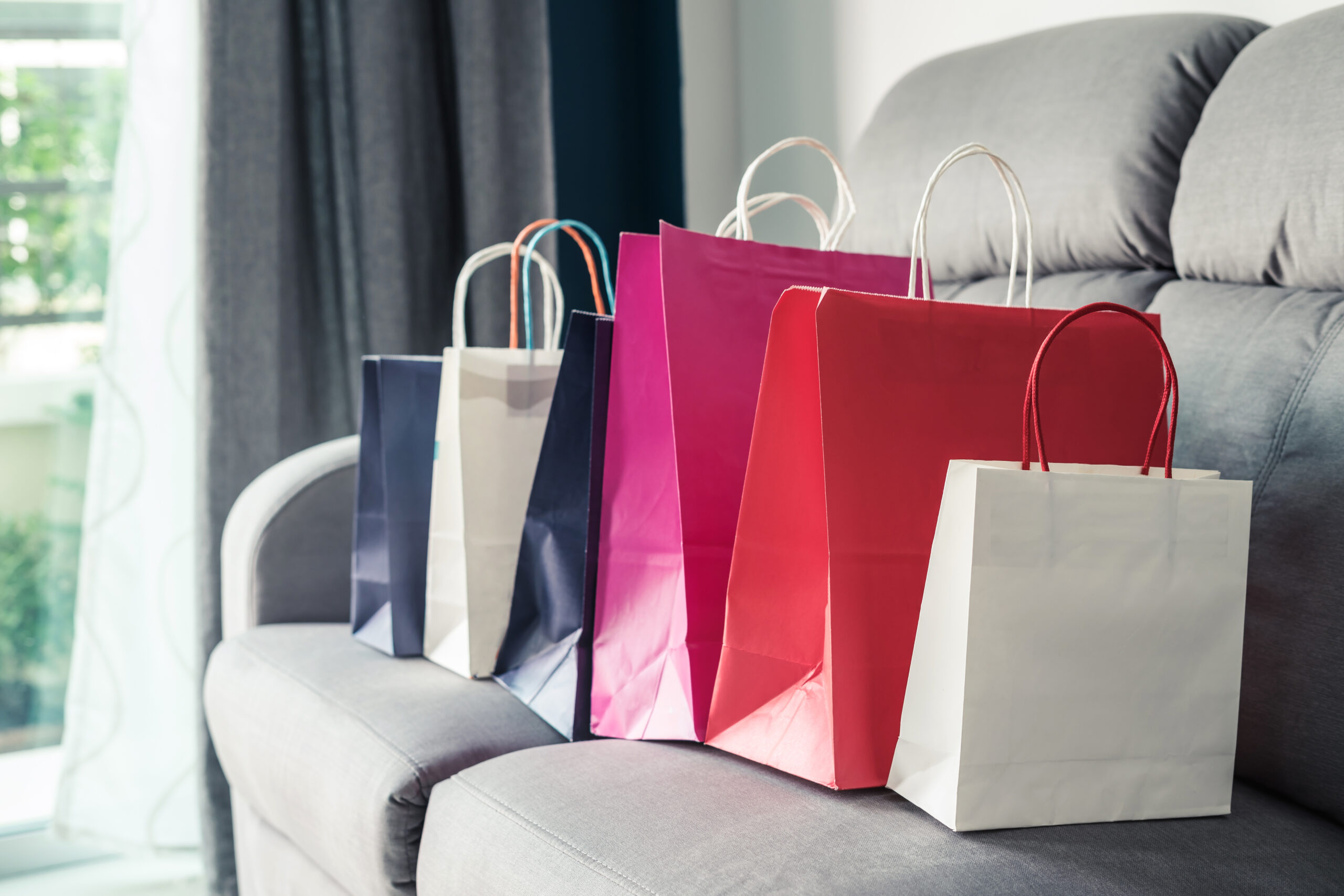 colorful shopping bags on sofa at home 2026 01 08 22 55 21 utc