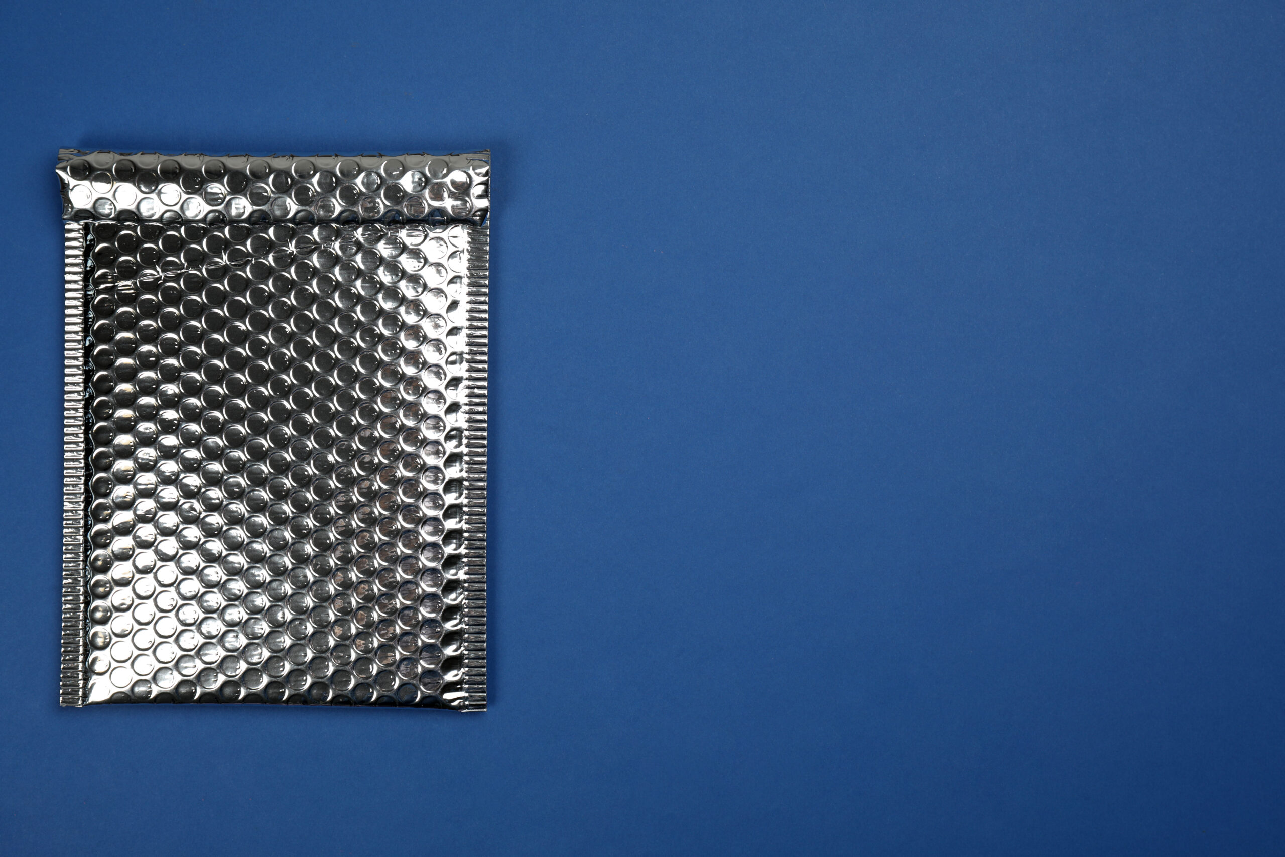 padded envelope with bubble wrap on blue backgroun 2026 03 27 00 54 37 utc