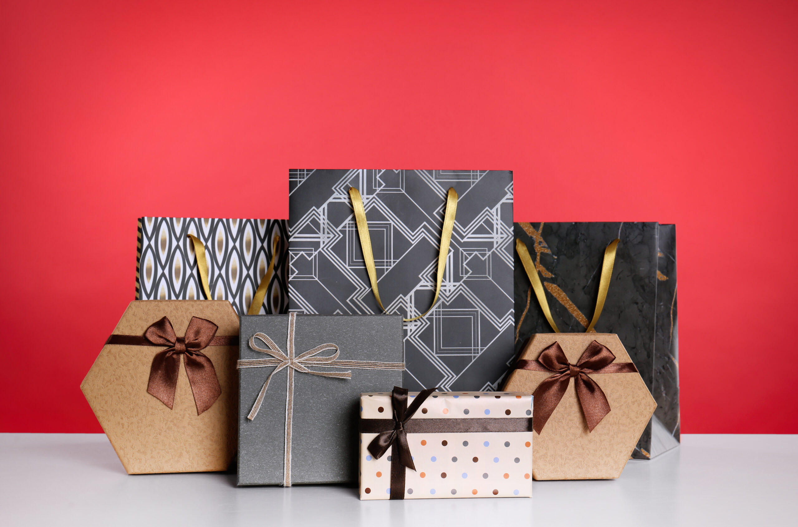 shopping paper bags and gift boxes on red backgrou 2026 03 20 04 45 48 utc