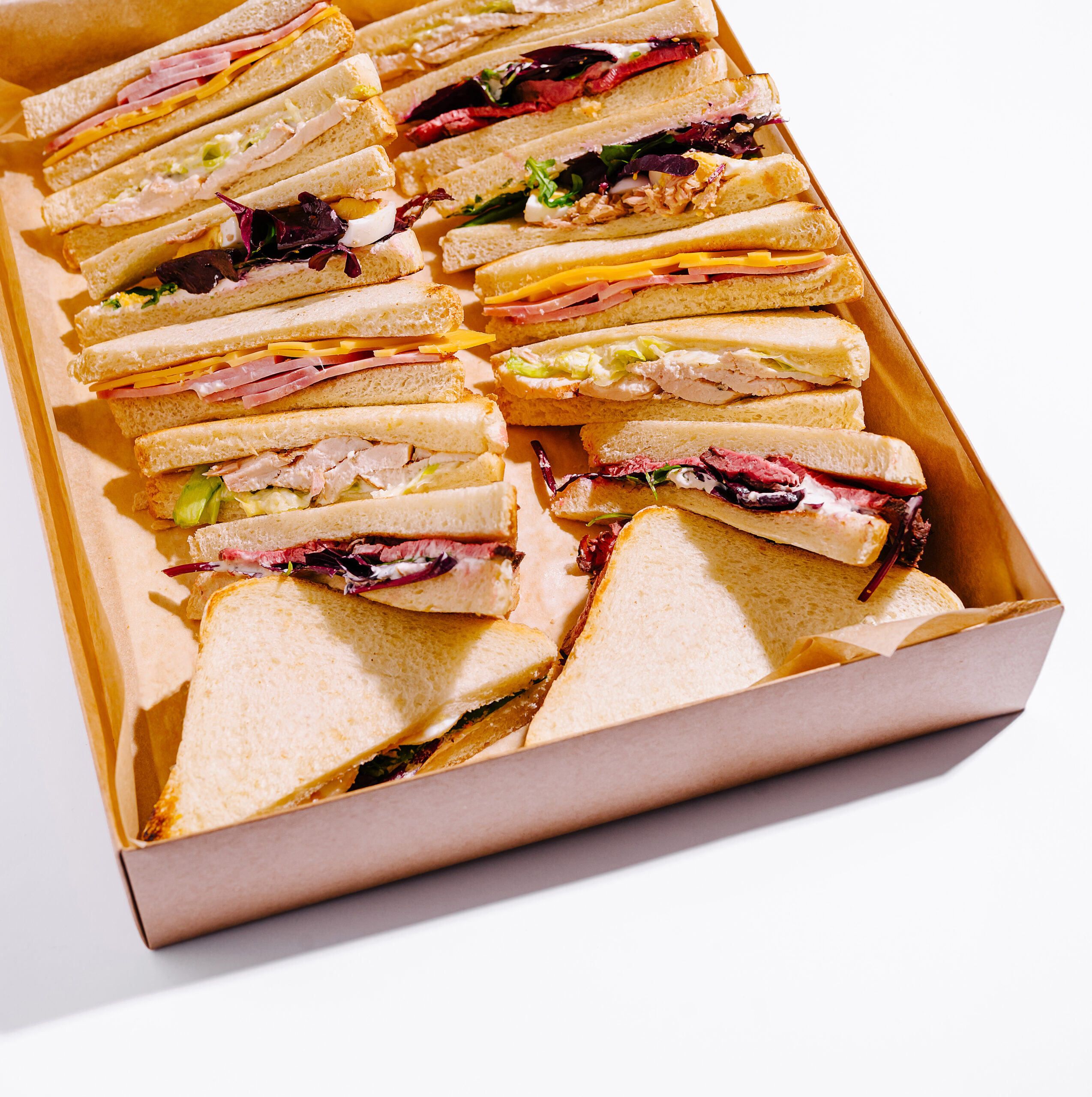 various sandwiches arranged in a takeout box for a 2026 03 24 05 09 09 utc
