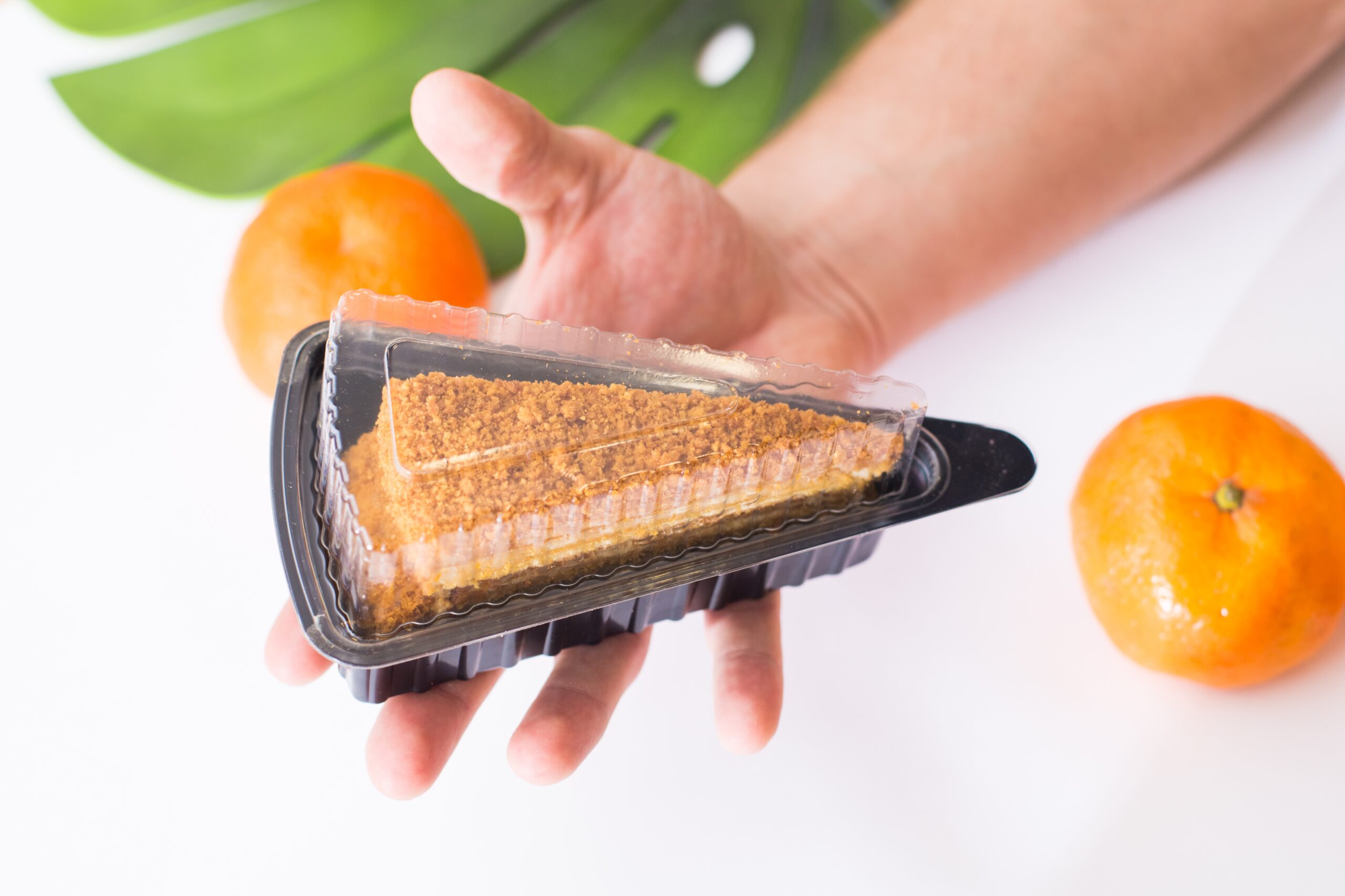 a man holds a plastic triangular package with a pi 2026 01 06 11 01 06 utc