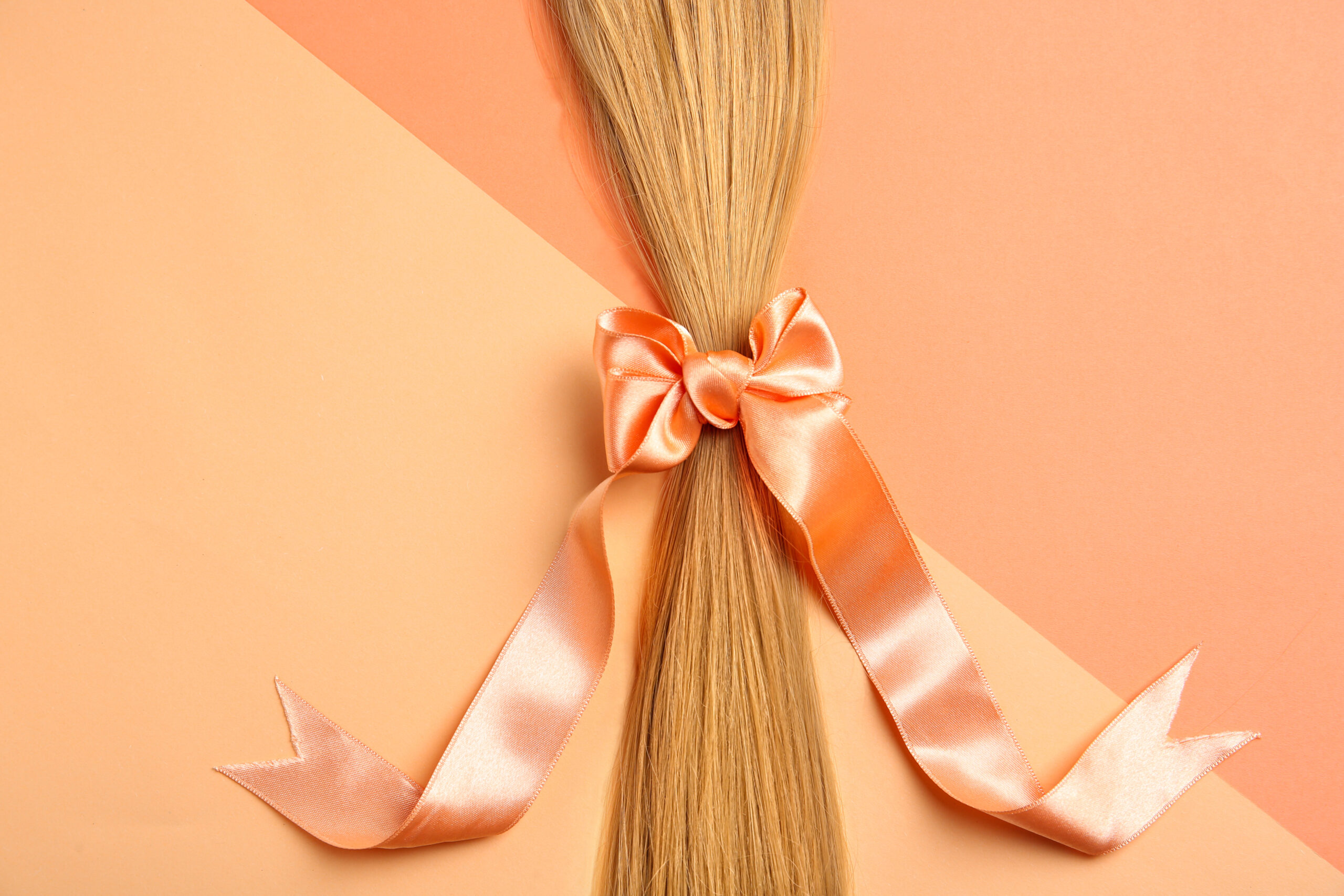 blond hair tied with ribbon on color background t 2026 03 05 11 50 11 utc