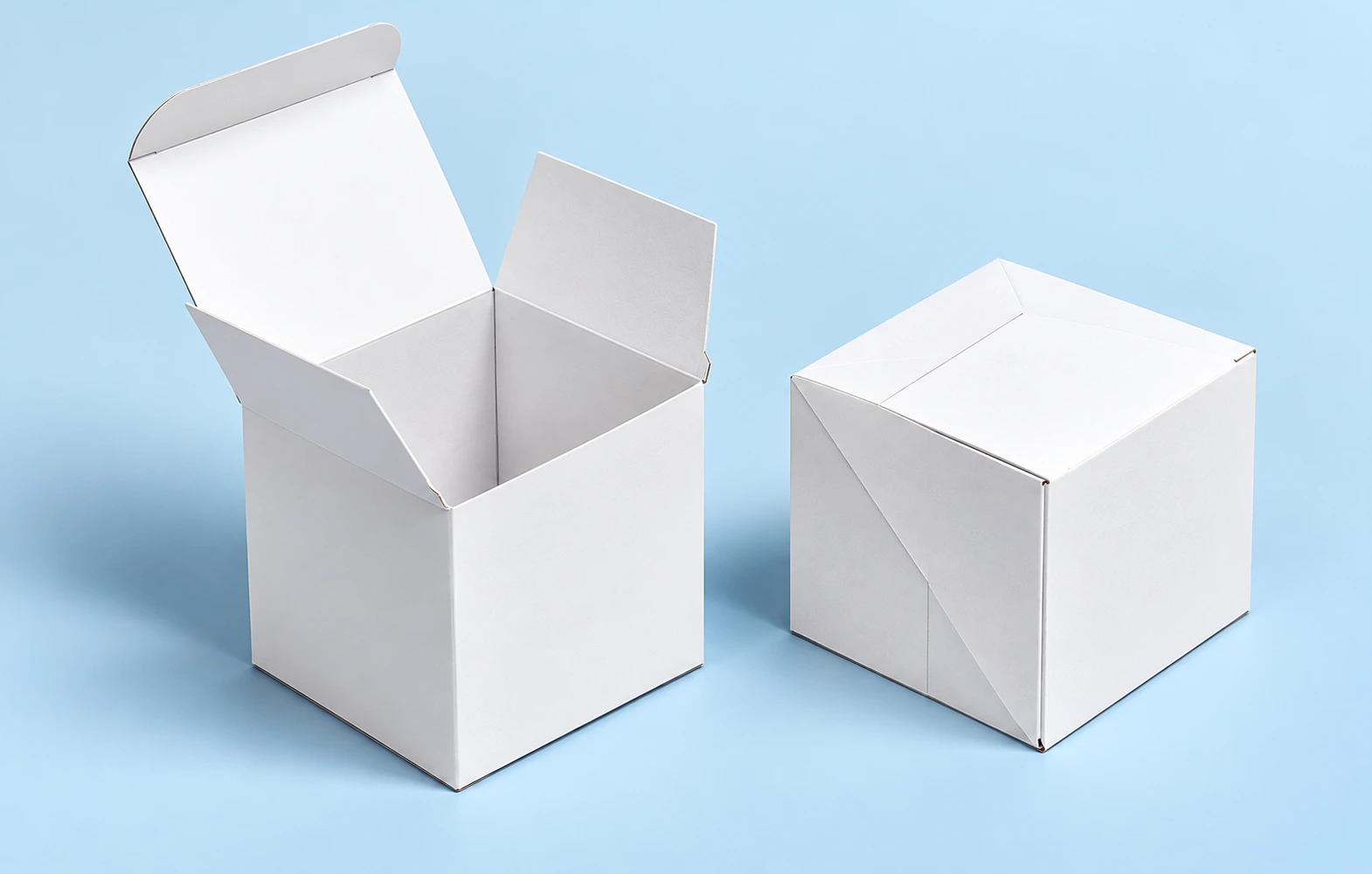 Kraft corrugated mailer box with hinged lid, side ears and front tuck flap open, purple tissue inside
