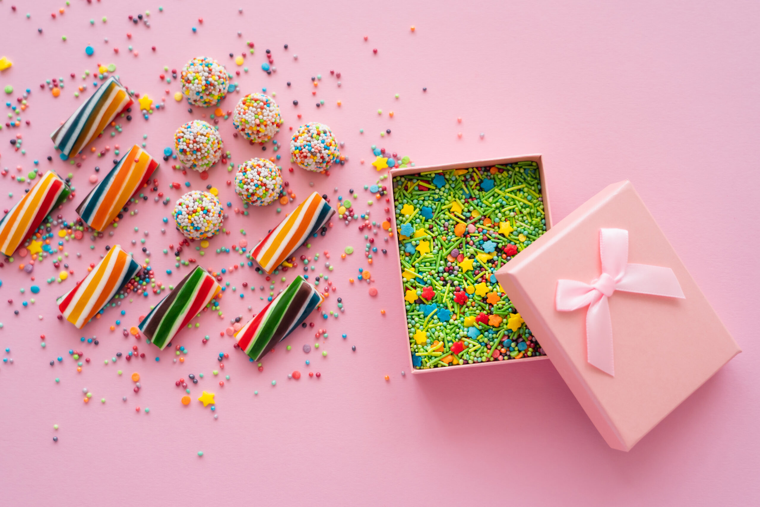 top view of colorful sweets near gift box with spr 2026 01 11 10 47 08 utc