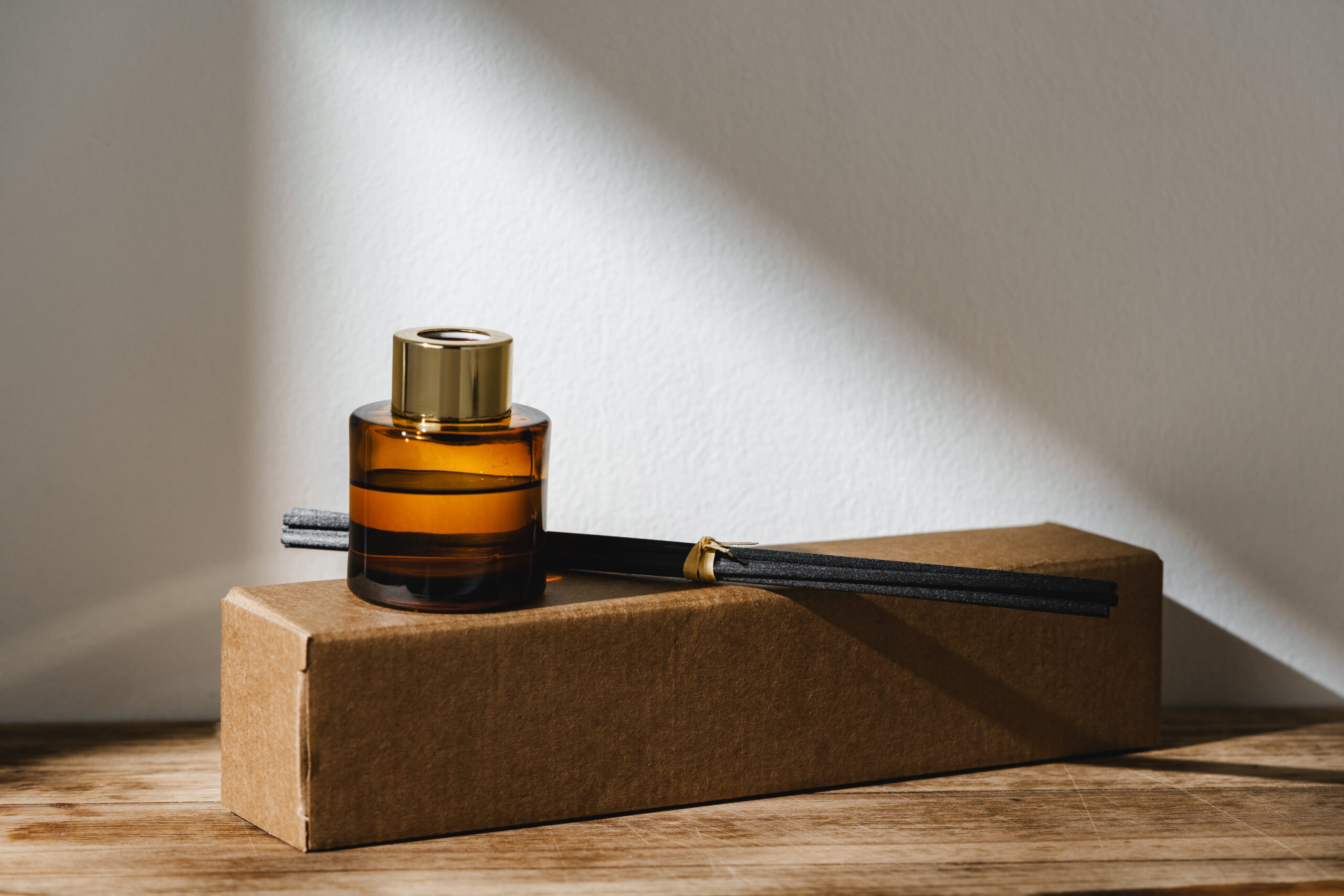 elegant reed diffuser with shadows on wooden surfa 2026 03 19 07 08 30 utc