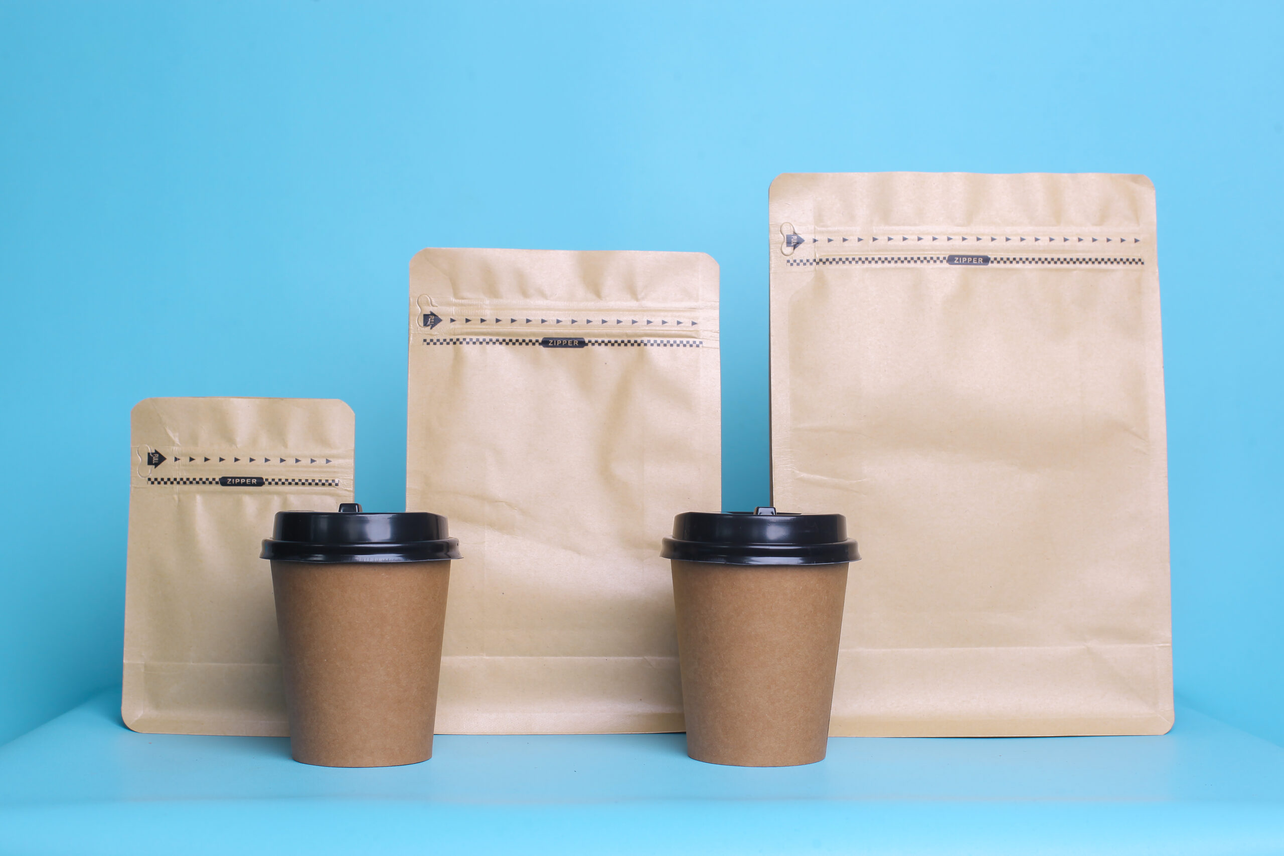 Kraft paper PET film pouches and takeaway coffee cups by Artsy Packaging UK