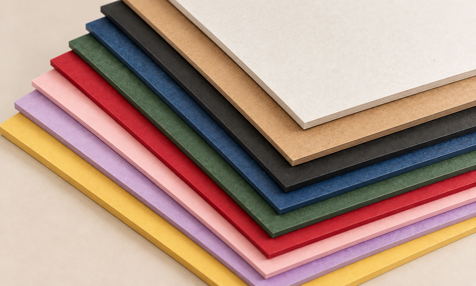 Colorful dyed paperboard material swatches in red green blue black and yellow by Artsy Packaging UK