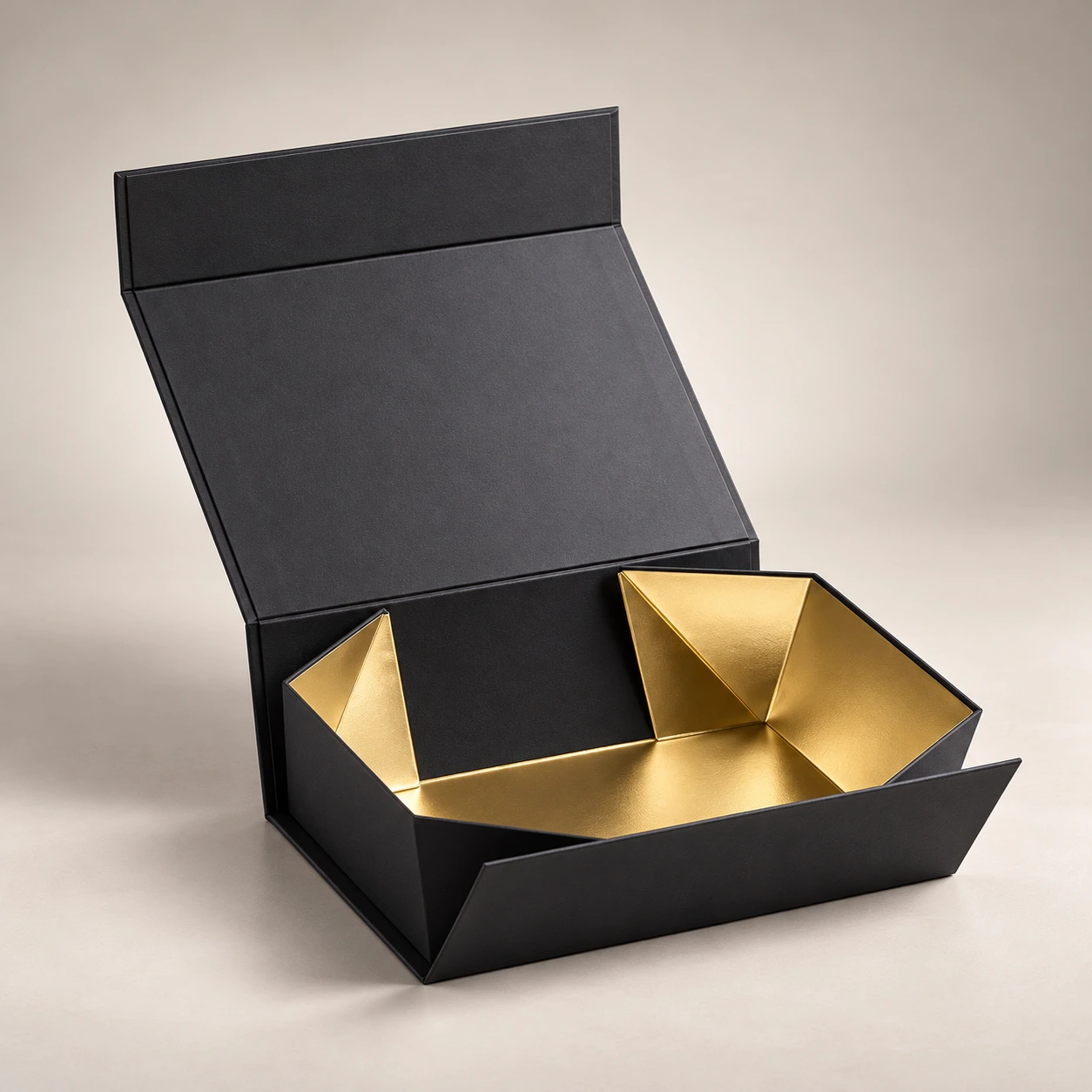 Custom Magnetic Closure Boxes featuring matte black collapsible rigid packaging with a metallic gold foil lined interior for luxury cosmetics, gifts, and electronics.