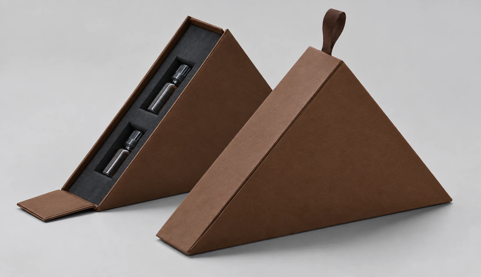 Die Cut Rigid Boxes featuring triangular brown setup boxes with custom foam inserts for precision bottle packaging and specialty gifts.