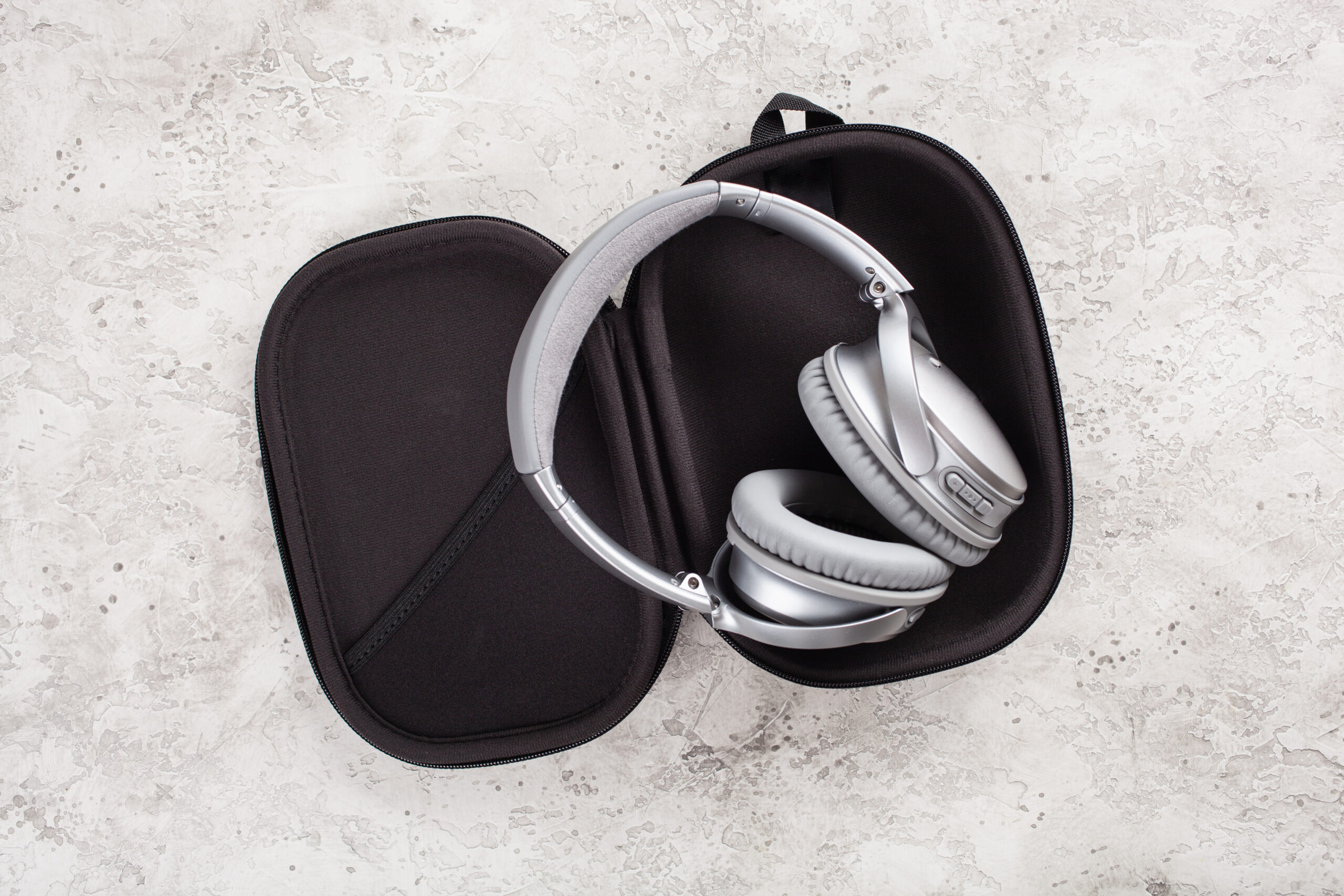 modern silver wireless headphones on concrete back 2026 03 09 08 14 00 utc