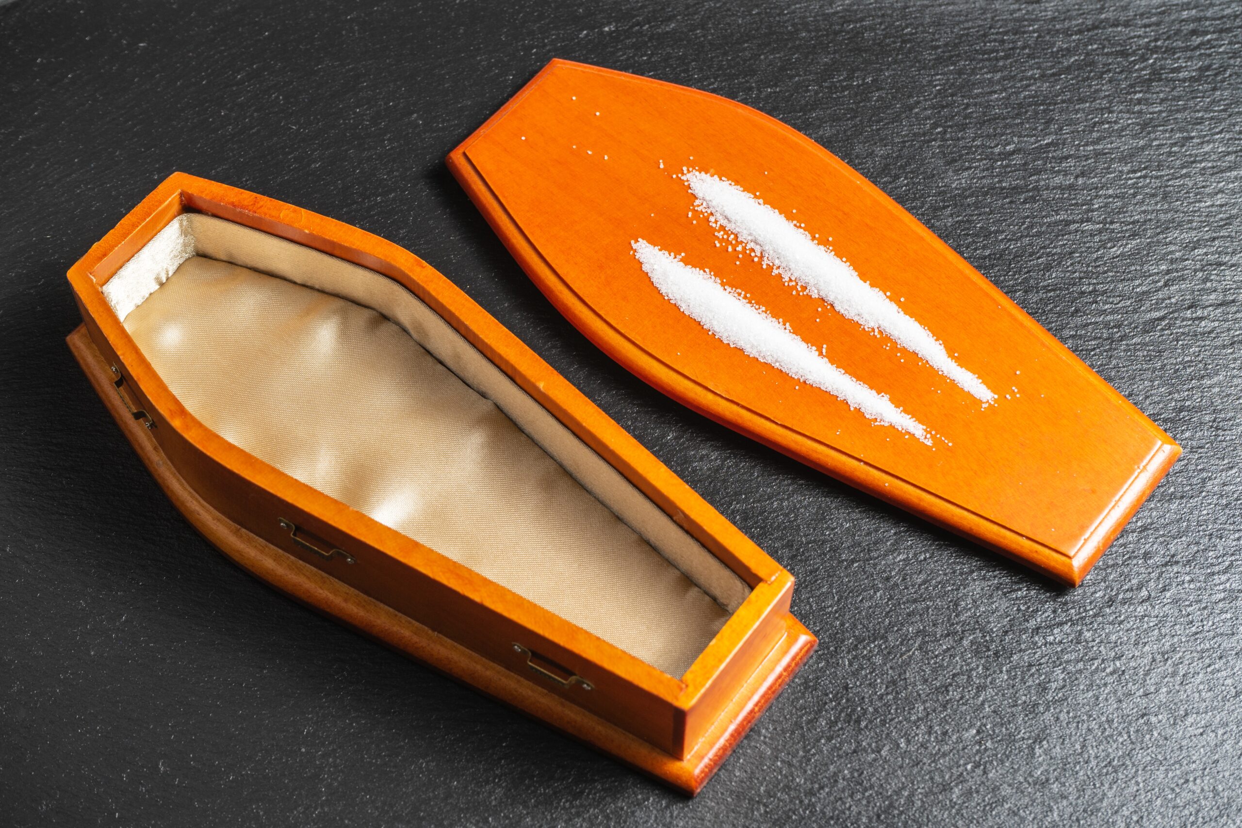 open coffin with two lines of white powder 2026 03 13 04 24 39 utc