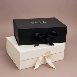 Rigid Gift Boxes featuring elegant black and cream luxury presentation boxes tied with satin ribbons and foil stamping for premium gifting.