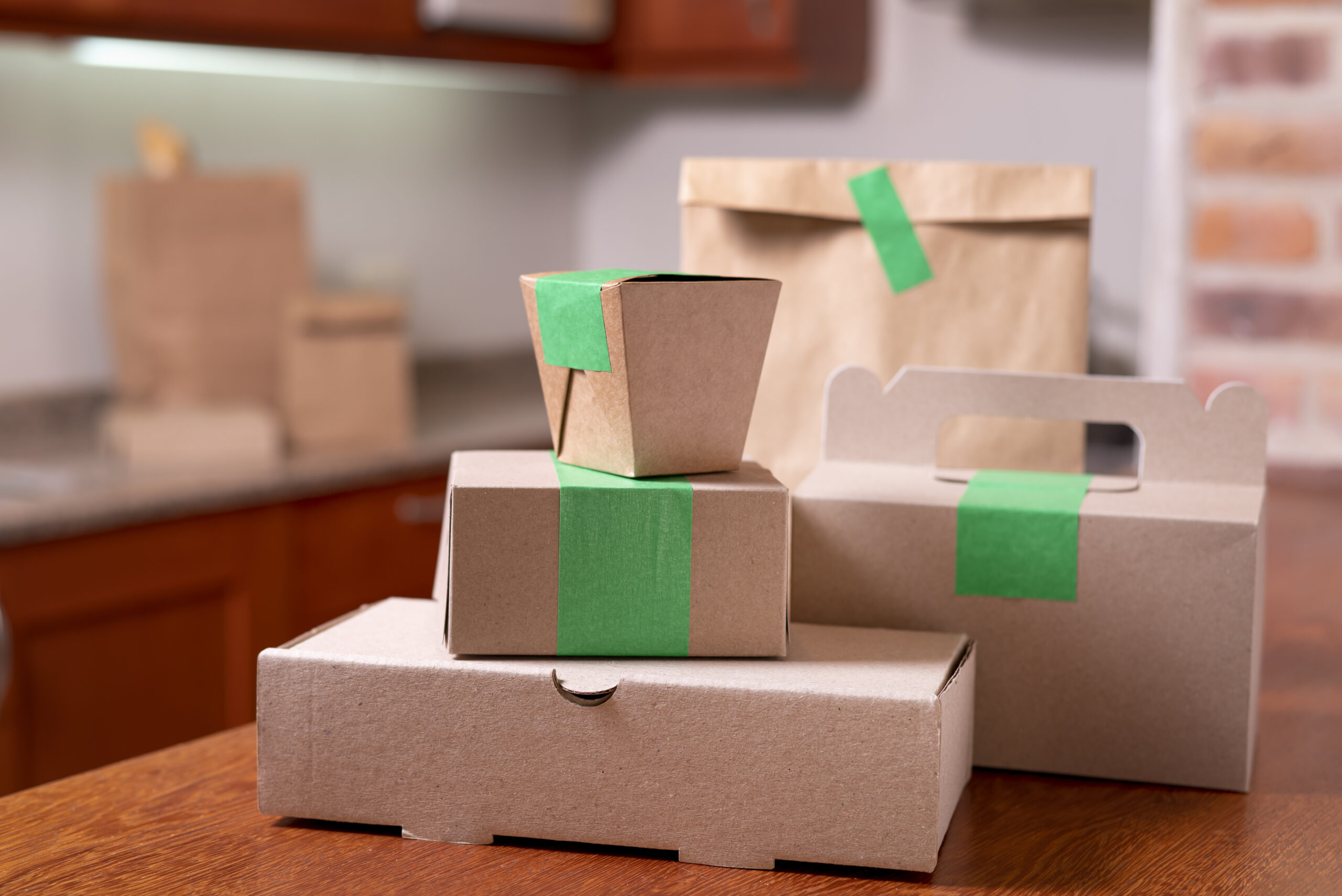 FSC-Certified and Recyclable Materials showcasing sustainable kraft paperboard boxes and bags sealed with green tape for eco-friendly custom packaging solutions.
