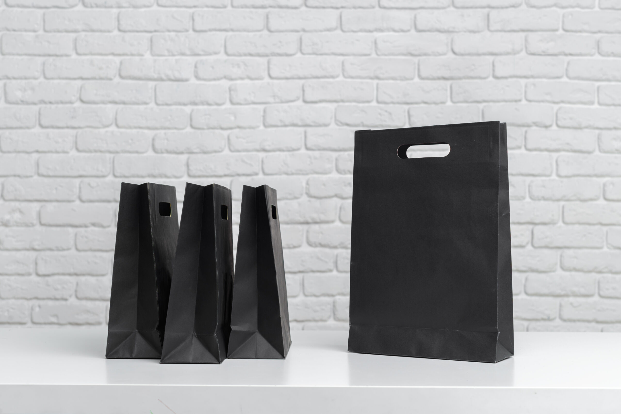various black shopping bags placed on a table next 2026 02 08 05 53 47 utc