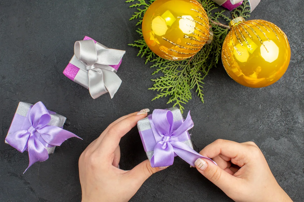 view-hand-holding-one-colorful-gifts-decoration-accessories-dark-background.webp