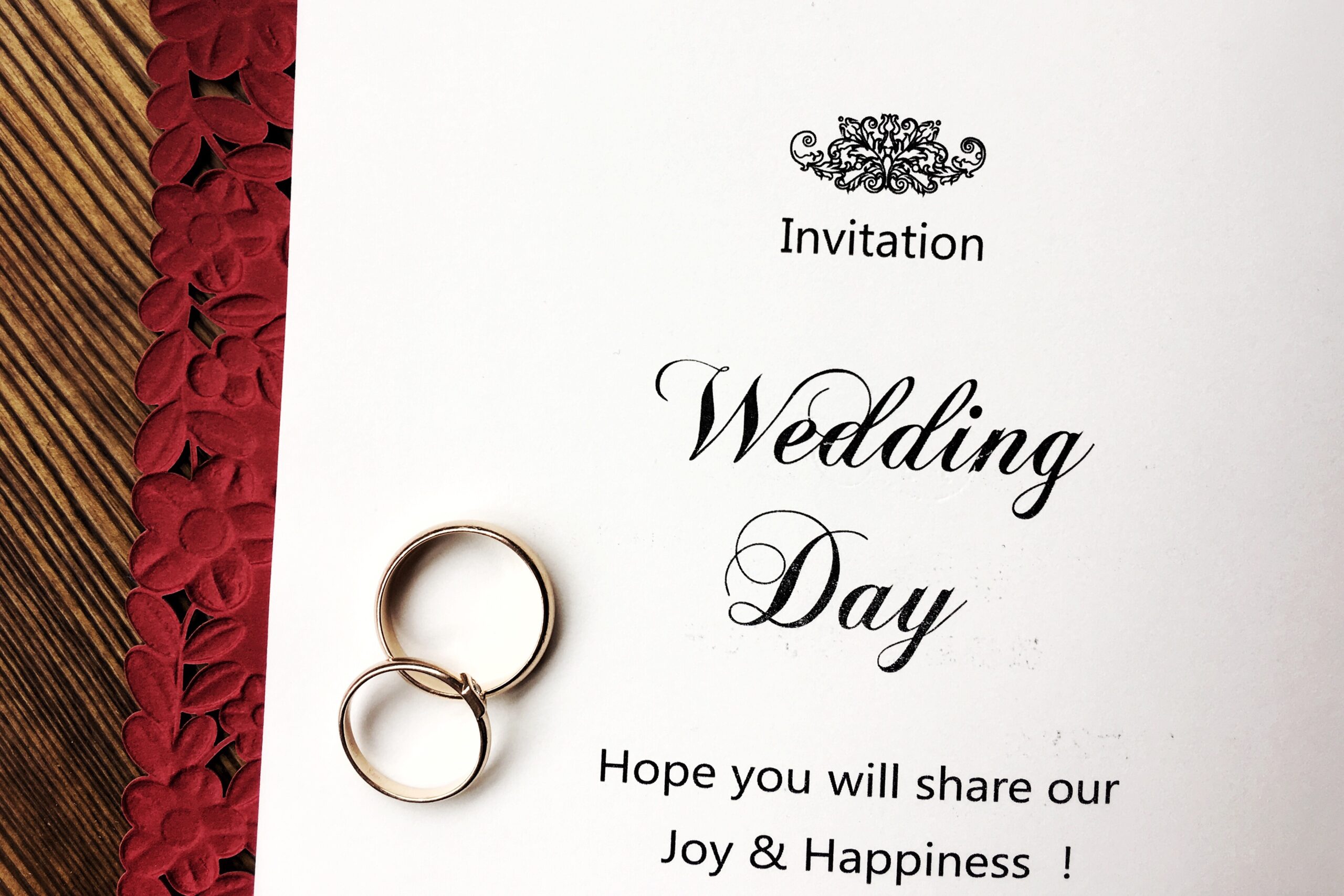 wedding invitation and rings are on a red envelope 2026 01 05 23 38 18 utc