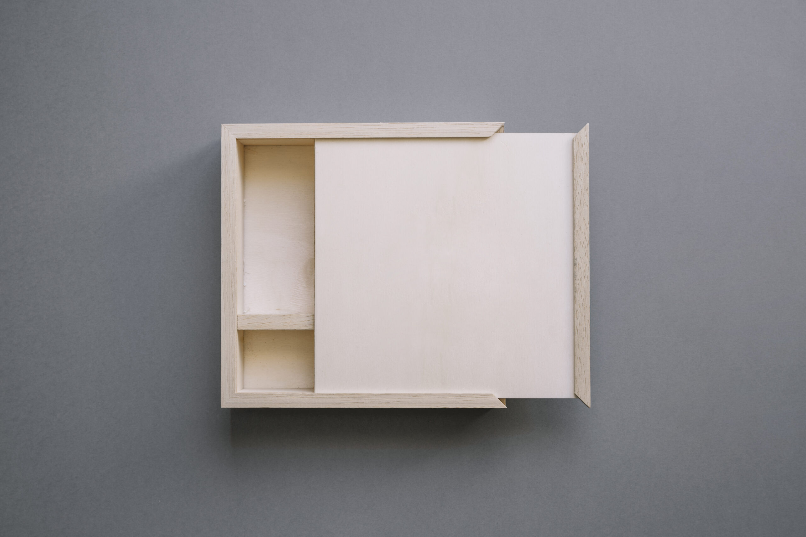 Custom rigid box with cardboard dividers for product protection and organized presentation.