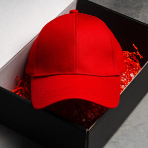 red baseball cap in cardboard box close up 2026 01 08 22 33 00 utc
