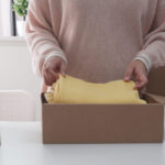 women packing cardboard parcel box for online sell 2026 01 06 09 41 25 utc