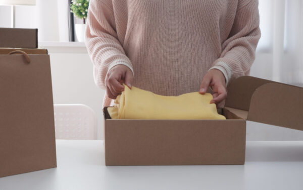 women packing cardboard parcel box for online sell 2026 01 06 09 41 25 utc