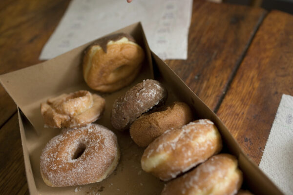 a box of assorted donuts on a wooden table ready f 2026 01 09 08 25 08 utc