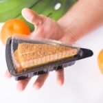 a man holds a plastic triangular package with a pi 2026 01 06 11 01 06 utc