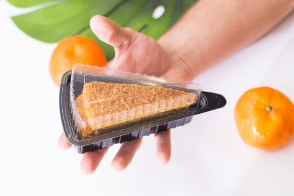 a man holds a plastic triangular package with a pi 2026 01 06 11 01 06 utc