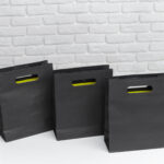 black shopping bags arranged on a surface with a p 2026 02 08 05 53 48 utc