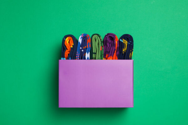 box with socks on green background top view 2026 01 09 08 23 03 utc