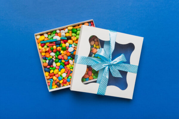 box with sweet chocolate candies on color backgrou 2026 02 01 06 04 49 utc