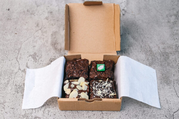 brownies with various topping on cardboard box 2026 01 08 23 38 00 utc