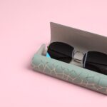 case with stylish sunglasses on light pink backgro 2026 01 11 11 10 19 utc