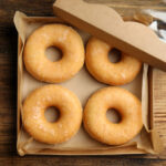 delicious donuts on wooden table top view 2026 01 05 20 29 04 utc