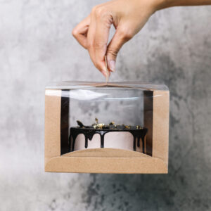 hands holds box of tart cake 2026 01 08 23 38 01 utc