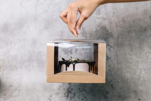 hands holds box of tart cake 2026 01 08 23 38 01 utc