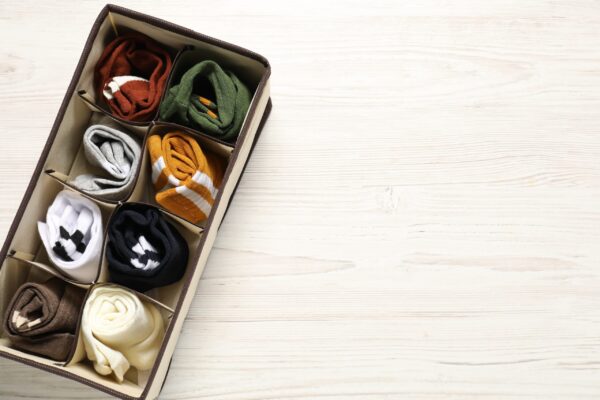 organizer with different socks on wooden table to 2026 01 11 11 11 03 utc