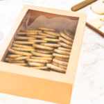 packing sprinkle adorned sugar cookies into boxes 2026 01 08 02 10 43 utc