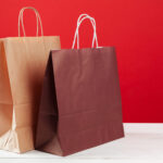 several shopping bags with copy space on red backg 2026 01 08 06 05 01 utc