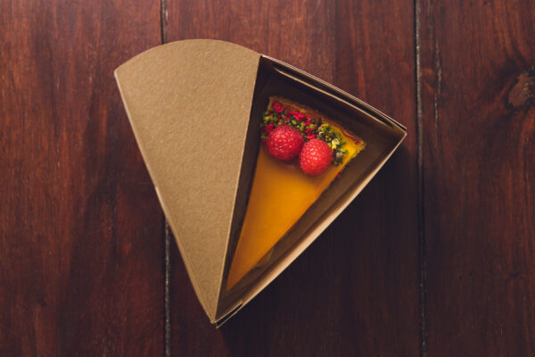 top view of a mango cheesecake with raspberries in 2026 01 07 07 16 22 utc