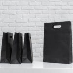 various black shopping bags placed on a table next 2026 02 08 05 53 47 utc