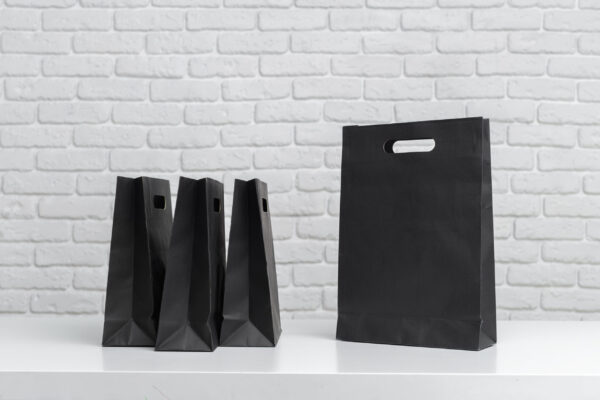 various black shopping bags placed on a table next 2026 02 08 05 53 47 utc