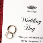 wedding invitation and rings are on a red envelope 2026 01 05 23 38 18 utc