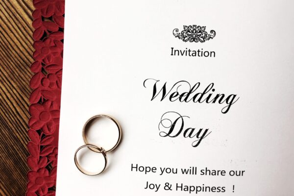 wedding invitation and rings are on a red envelope 2026 01 05 23 38 18 utc