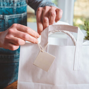 white package gift and tag woman hands make bow 2026 01 11 08 09 53 utc