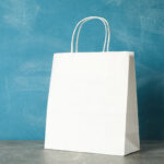 white paper bag on grey table against blue backgro 2026 01 09 08 05 04 utc