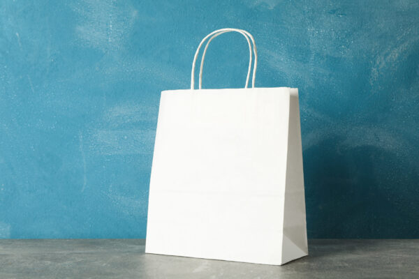 white paper bag on grey table against blue backgro 2026 01 09 08 05 04 utc