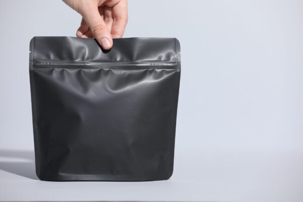 woman holding blank zipper stand up pouch on light 2026 01 11 10 52 25 utc